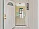 Open entryway with tile floors providing a clear view into the home's interior at 6023 Mayberry Ave, North Port, FL 34287