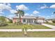 Charming single-story home featuring a well-manicured lawn and attractive landscaping at 6023 Mayberry Ave, North Port, FL 34287