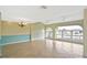 Bright living room featuring large windows, tile flooring, and modern ceiling fans at 6023 Mayberry Ave, North Port, FL 34287