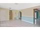 Spacious living area with tile flooring and arched doorway, offering a seamless flow at 6023 Mayberry Ave, North Port, FL 34287