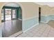 Open floor plan showcasing tile flooring and an archway leading to the outdoor pool area at 6023 Mayberry Ave, North Port, FL 34287
