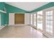 Bright sunroom with tile flooring and sliding doors leading to the pool area at 6023 Mayberry Ave, North Port, FL 34287
