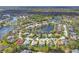 An aerial view of a serene neighborhood and several homes surrounding a small lake at 6357 Royal Tern Cir, Lakewood Ranch, FL 34202