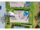 An aerial view of a home featuring a screen enclosed pool, well manicured yard and driveway at 6357 Royal Tern Cir, Lakewood Ranch, FL 34202