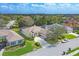 Aerial view of home with manicured lawn, mature trees, and a long private drive at 6357 Royal Tern Cir, Lakewood Ranch, FL 34202