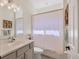 Bathroom vanity with single sink, patterned shower curtain, and decorative fixtures at 6357 Royal Tern Cir, Lakewood Ranch, FL 34202