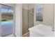 Bathroom featuring a glass-enclosed shower with a view of the screened-in pool at 6357 Royal Tern Cir, Lakewood Ranch, FL 34202