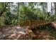 Wooden bridge on a nature trail through a beautiful wooded area for outdoor recreation at 6357 Royal Tern Cir, Lakewood Ranch, FL 34202