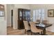 Dining area featuring a dark wood table, comfortable seating and shuttered windows at 6357 Royal Tern Cir, Lakewood Ranch, FL 34202