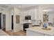 Bright kitchen featuring white cabinets, stainless steel appliances, and a neutral backsplash at 6357 Royal Tern Cir, Lakewood Ranch, FL 34202