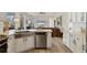 The kitchen's stainless steel appliances and white cabinets complement the adjacent living area at 6357 Royal Tern Cir, Lakewood Ranch, FL 34202