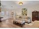 Cozy and well lit living room with wood floors, decorative art, and front door access at 6357 Royal Tern Cir, Lakewood Ranch, FL 34202