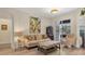 Bright living room showcasing neutral walls, light wood floors and sliding doors to patio at 6357 Royal Tern Cir, Lakewood Ranch, FL 34202