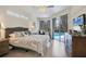 The main bedroom features neutral tones, ample natural light, and private access to the pool at 6357 Royal Tern Cir, Lakewood Ranch, FL 34202