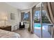 Bright main bedroom features neutral tones, a window seat, and access to the pool at 6357 Royal Tern Cir, Lakewood Ranch, FL 34202
