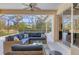 Screened patio with comfortable seating and ceiling fan, perfect for relaxing outdoors at 6357 Royal Tern Cir, Lakewood Ranch, FL 34202