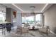 Contemporary living room featuring a linear fireplace, modern lighting, and beautiful city views at 688 Golden Gate Point # 302, Sarasota, FL 34236