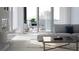 Beautiful living room with fireplace, modern furnishings, and balcony access with city views at 688 Golden Gate Point # 302, Sarasota, FL 34236