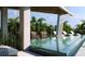 Gorgeous pool area surrounded by lush tropical greenery and comfortable lounge seating at 688 Golden Gate Point # 302, Sarasota, FL 34236