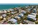 Aerial view of beach neighborhood featuring a charming home with a backyard pool and lush tropical landscaping at 709 N Bay Blvd, Anna Maria, FL 34216