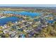 Aerial view of a lakeside community with beautiful homes, waterways, and lush landscaping at 7135 Royal George Ct, Wesley Chapel, FL 33545