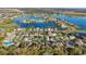 Stunning aerial view of waterfront community with houses surrounding a beautiful blue lake at 7135 Royal George Ct, Wesley Chapel, FL 33545