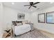 Comfortable bedroom with hardwood floors, a ceiling fan, and natural light at 7135 Royal George Ct, Wesley Chapel, FL 33545