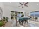 Bright dining room featuring ceiling fan, dining table, and sliding glass door to outside patio at 7135 Royal George Ct, Wesley Chapel, FL 33545