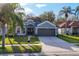 Charming home features a well-maintained lawn and a two-car garage at 7135 Royal George Ct, Wesley Chapel, FL 33545