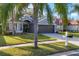 Home with lush lawn and tidy landscaping, and a driveway leading to the garage at 7135 Royal George Ct, Wesley Chapel, FL 33545