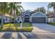 Beautifully landscaped front yard and driveway lead to the inviting two-car garage at 7135 Royal George Ct, Wesley Chapel, FL 33545