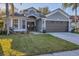 Well-manicured lawn, lovely plantings and double front doors add to the curb appeal at 7135 Royal George Ct, Wesley Chapel, FL 33545