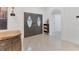 Bright foyer with double doors, tile flooring, and contemporary lighting at 7135 Royal George Ct, Wesley Chapel, FL 33545