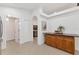Hallway with granite countertop bar area, white trim and interior doors, and neutral tile floor at 7135 Royal George Ct, Wesley Chapel, FL 33545