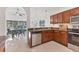 Bright kitchen featuring granite countertops, stainless steel appliances, and wood cabinets at 7135 Royal George Ct, Wesley Chapel, FL 33545
