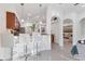 Kitchen with bar seating and stainless steel appliances, leading to a large living area at 7135 Royal George Ct, Wesley Chapel, FL 33545