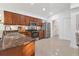 Well-lit kitchen featuring stainless steel appliances, granite countertops, and beautiful wood cabinetry at 7135 Royal George Ct, Wesley Chapel, FL 33545