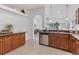 Bright kitchen featuring granite countertops, stainless steel appliances, and wood cabinets at 7135 Royal George Ct, Wesley Chapel, FL 33545