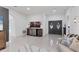 Bright living room boasts tile floors, art, double door entry, and unique barrel-themed bar at 7135 Royal George Ct, Wesley Chapel, FL 33545