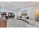 Bright living room with tile floors, modern decor and a comfortable sectional sofa at 7135 Royal George Ct, Wesley Chapel, FL 33545