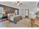 Beautiful main bedroom featuring a ceiling fan, hardwood floors, and a large rug at 7135 Royal George Ct, Wesley Chapel, FL 33545