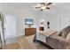 Bright main bedroom with hardwood floors, a TV, and ensuite bathroom access at 7135 Royal George Ct, Wesley Chapel, FL 33545