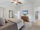 Beautiful main bedroom with hardwood floors, a TV, and an ensuite bathroom at 7135 Royal George Ct, Wesley Chapel, FL 33545