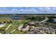 Aerial photograph features the community's lush golf course, a lake, and the clubhouse at 7213 Whittlebury Trl, Bradenton, FL 34202