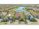 Stunning aerial view of a private home near a pond in a beautiful community with lush surroundings at 7213 Whittlebury Trl, Lakewood Ranch, FL 34202