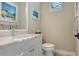Cozy bathroom showcasing a white vanity, neutral walls, and a minimalist design at 7213 Whittlebury Trl, Lakewood Ranch, FL 34202