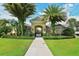 Inviting community entrance featuring lush greenery and a charming archway leading to the amenities at 7213 Whittlebury Trl, Lakewood Ranch, FL 34202