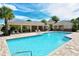 Large community pool offering a pristine area for relaxation and swimming surrounded by palm trees at 7213 Whittlebury Trl, Lakewood Ranch, FL 34202