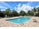 A refreshing community pool with ample seating, lounge chairs, and lush landscaping for relaxation at 7213 Whittlebury Trl, Lakewood Ranch, FL 34202