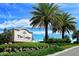 A view of the community sign for 'The Lodge at Lakewood Ranch Golf & Country Club' under blue skies and palm trees at 7213 Whittlebury Trl, Bradenton, FL 34202